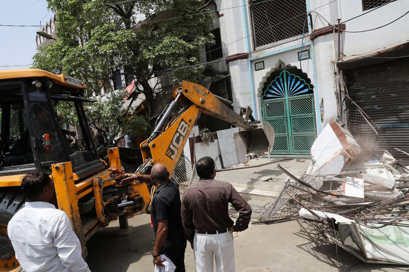 Demolishing Muslim homes with British machinery Demolishing Muslim homes with British machinery