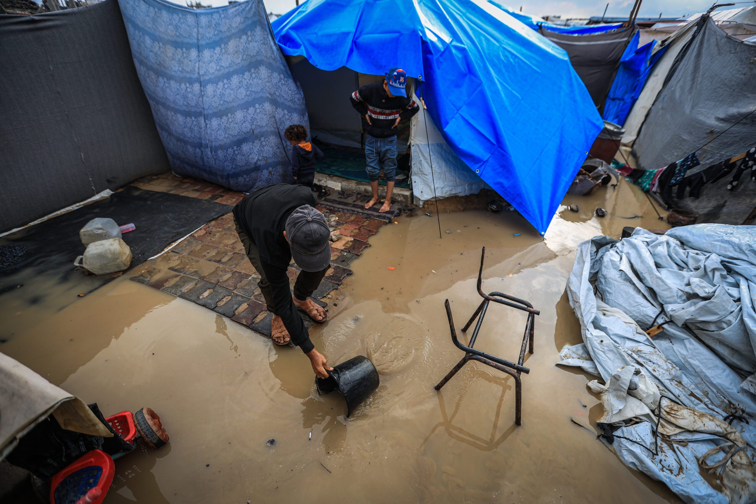 A humanitarian disaster unfolding: Gaza flooded, freezing, and cut off from aid